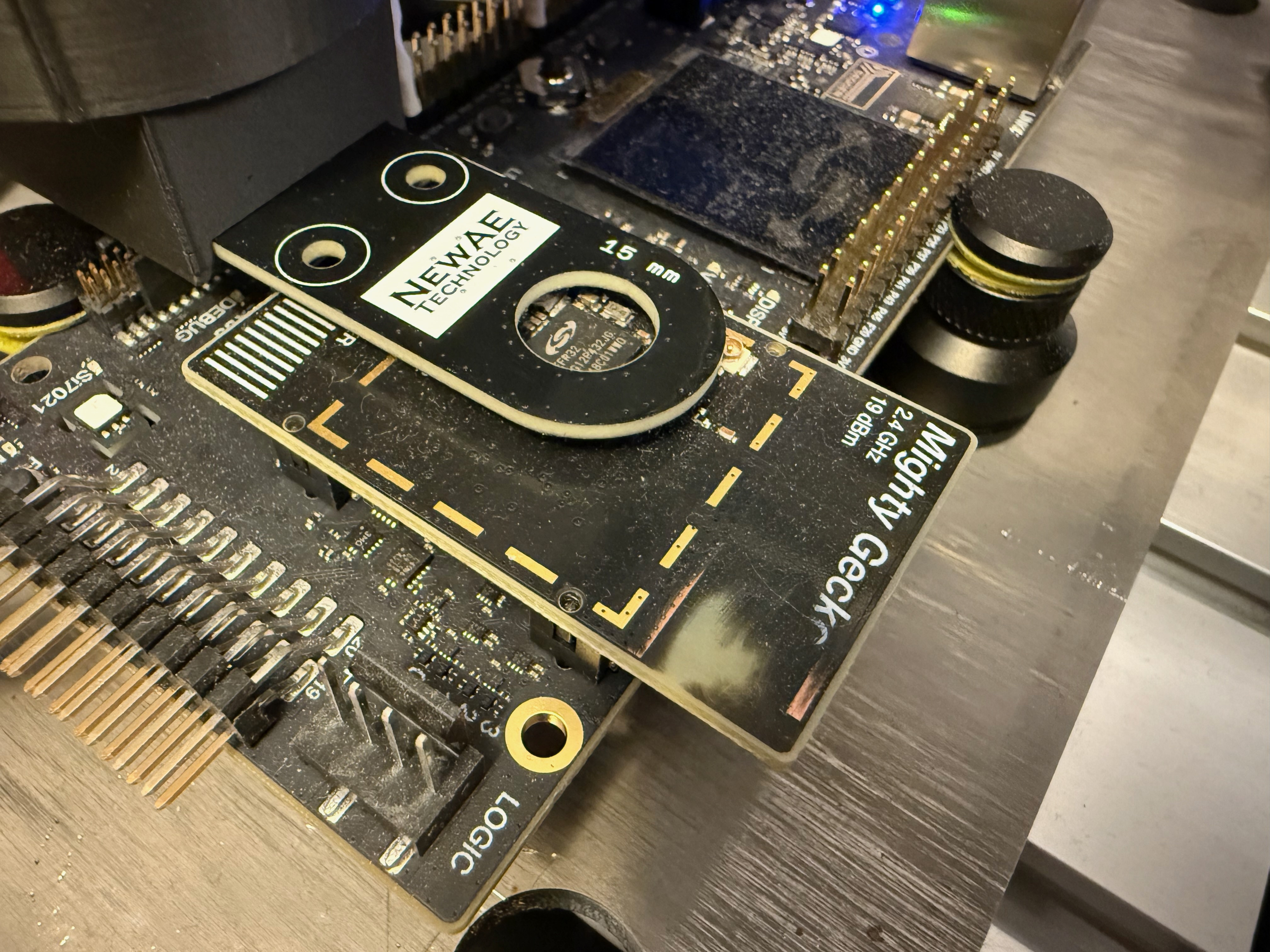 NewAE planar H-field probe held over the EFR32MG12 on the Mighty Gecko development board.